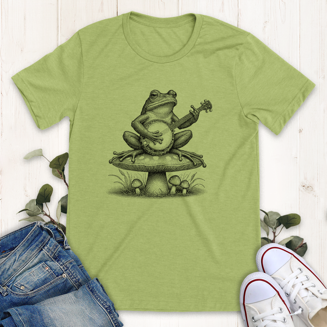 Heather green Banjo frog on a mushroom graphic t-shirt by Thistle and Brass